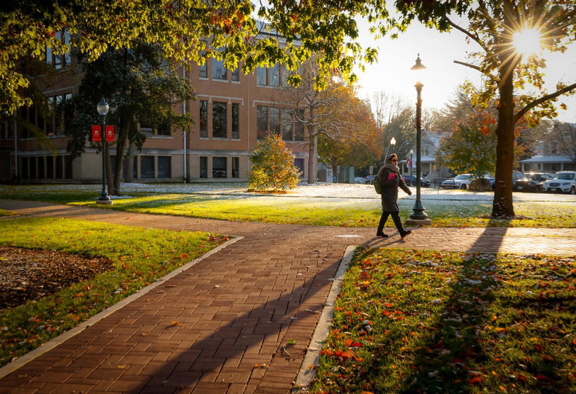 A North Central College student walking from a parking lot to class.