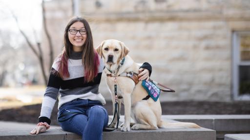 student posing with service dog